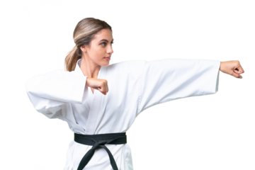 Young Uruguayan woman over isolated background doing karate