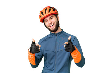 Young cyclist man over isolated chroma key background pointing to the front and smiling