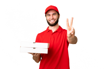 pizza delivery man with work uniform picking up pizza boxes over isolated chroma key background smiling and showing victory sign