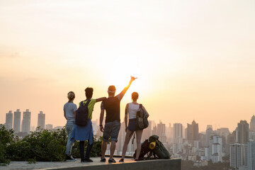Friends enjoying sunset view from rooftop