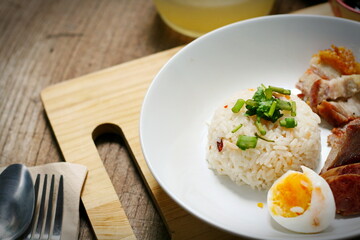 Tasty fried pork topped with sauce and served with rice and fresh cucumbers