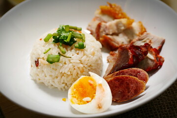 Tasty fried pork topped with sauce and served with rice and fresh cucumbers