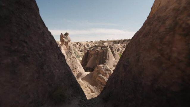 The camera flies through a canyon between the rocks and reveals a view of the ancient stones in the Valley of Imagination.