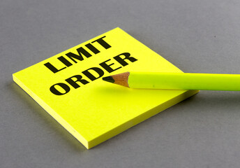 LIMIT ORDER text written on a sticky on grey background