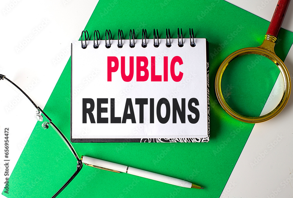 Poster public relations text on notebook on green paper