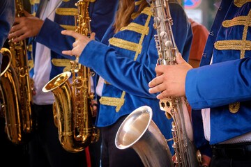  Close-up of a group of saxophonists in the foreground.