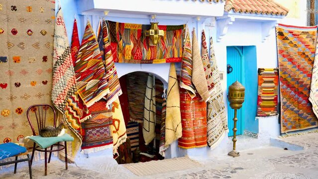 Traditional carpets on the blue Chefchaouen street- travel, tour tourism in Morocco