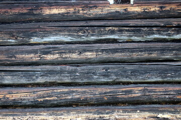 Abstract texture of old weathered logs lying on top of each other.