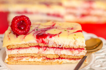 Cake with white chocolate and raspberry cream and red background