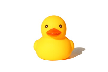 A yellow toy duck stands on a white background.