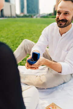 Happy man proposing woman with ring