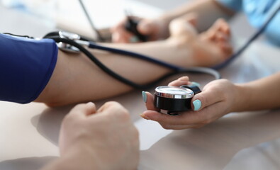 Female doctor hands male patient blood pressure measurement. Heart rate monitoring help cardiotherapist concept