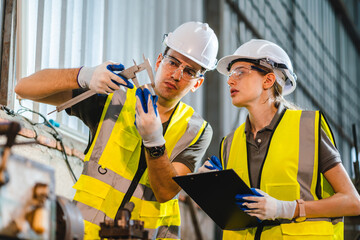 professional technician engineer checking mechanical factory equipment for using on industry machine, foreman with safety hard hat helmet working to maintenance control production job in manufacturing