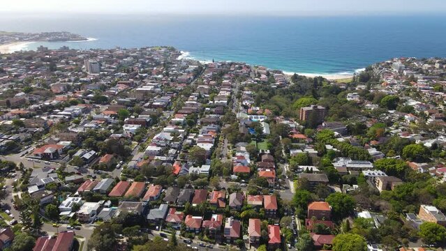 Aerial drone view of homes and streets above the beachside suburbs of Bronte and Tamarama, looking toward the Beaches in east Sydney, NSW Australia on a sunny morning 