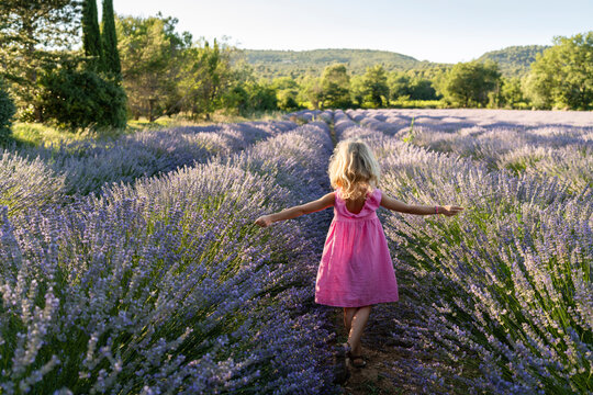 Carefree girl spending leisure time in lavender field