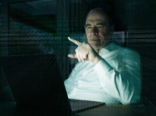 Businessman pointing on graphical user interface with binary codes in office