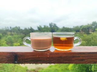  depicts two mugs of tea placed on a wooden table