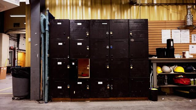 Set of Tall Textured Black Large Wooden Employee Infrastructure Hand Built Storage Lockers Inside an Industrial Shipping Warehouse