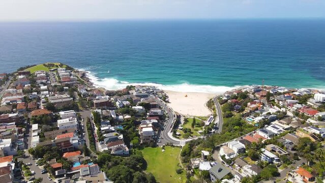 Aerial drone view of homes and streets above the beachside suburb of Tamarama, looking toward Tamarama Beach in east Sydney, NSW Australia on a sunny morning
