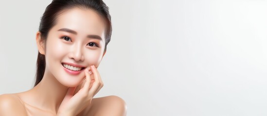 Young smile asian woman with stylish makeup touches her face and perfect skin.