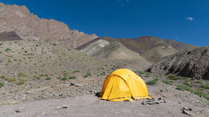 Wild camping in a yellow tent in the beautiful Himalayan mountain wilderness of Ladakh, India
