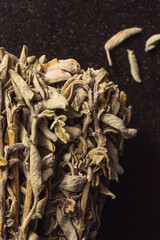 Dried sage bundle, closeup shot on black rustic background