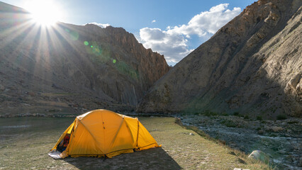 Wild camping in a yellow tent in the beautiful Himalayan mountain wilderness of Ladakh, India