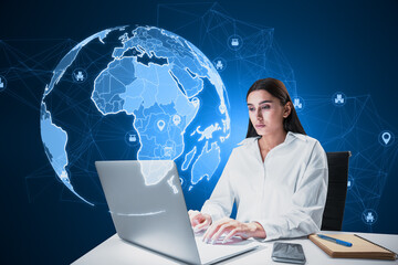 Attractive young european businesswoman at desktop using laptop computer with glowing polygonal...