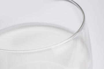 fresh milk in glass cup in close-up on white background taken from above