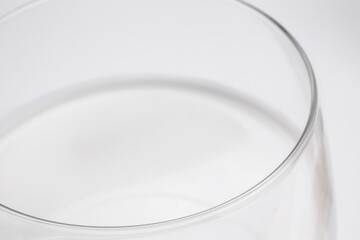 fresh milk in glass cup in close-up on white background taken from above