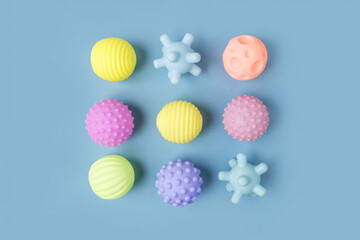 Tactile knobby balls, blue studio background. Sensory massage textured ball. Enhance the cognitive,...