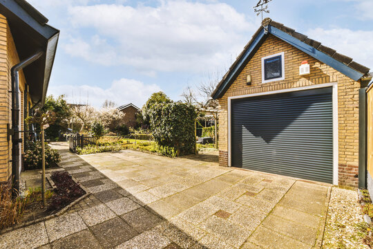 Garage with roller door outside house on sunny day