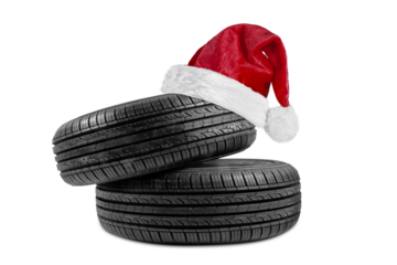 a black isolation rubber tire, with a Santa Claus hat for Christmas on a transparent background in PNG format