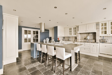 Chairs and island in large modern kitchen
