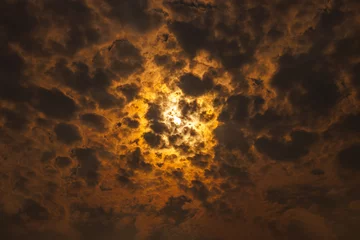 Foto auf Leinwand The sun shines through dark clouds © rob