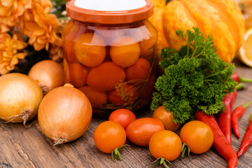 Canned cherry tomatoes in a jar. Cooking in the kitchen