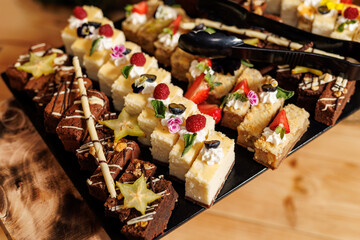 Set of sweet cakes and desserts at buffet.