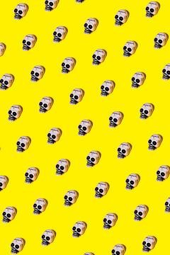 Set of illustrated skull composing rhomb on yellow backdrop