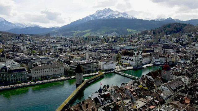 Panoramic Aerial View of the Urban architectural landscape of the city of Lucerne and Mount Pilatus in the background in Switzerland featuring the Reuss River, Spreuerbrücke, Reussbrücke, Seebrücke an