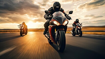 A group of motorcyclists ride sports bikes at fast speeds on an empty road against a beautiful cloudy sky.