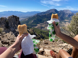 couple having lunch on top of a mountain