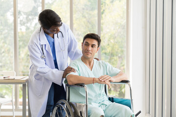 Obraz premium Nurse caring male patient with carefully on wheelchair at hospital. Female assistant taking care male patient on wheelchair at clinic. Healthcare and medical concept