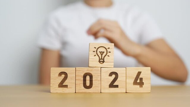 2024 block with lightbulb. Business Idea, Creative, Thinking, brainstorm, Goal, Resolution, strategy, plan, Action, change and New Year start concepts
