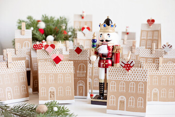 Handmade advent calendar. Houses shaped carton gift boxes. Eco friendly Christmas gifts diy concept