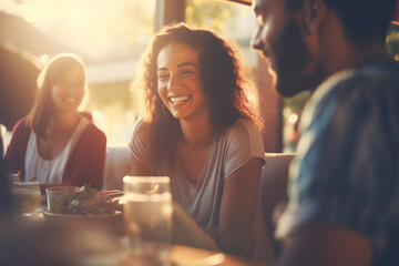 Group of cheerful friends having fun at dinner party. Multi-ethnic people having a get together outdoors.