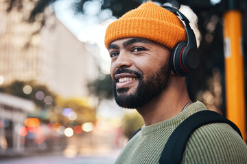 Smile, music headphones and man in city outdoor, listening to audio or sound track on internet to...