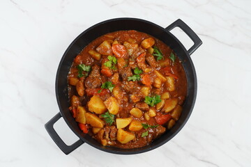 Traditional homemade Hungarian beef meat stew and soup  - Goulash with potatoes, carrots , tomatoes, bell pepper