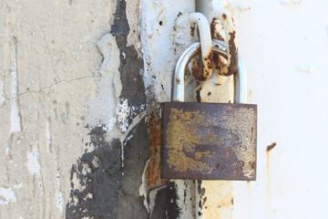 rusty padlock in the old door