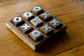 Wooden tic tac toe (O X) game. The concept of business strategy and competition