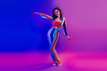 Full size portrait of gorgeous cheerful girl have good mood dancing chilling isolated on vibrant colorful neon background
